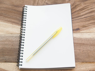 white note with yellw pen on wood table