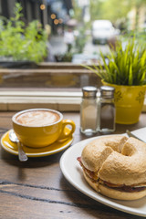 Obraz na płótnie Canvas Coffee and bagel in a cafe