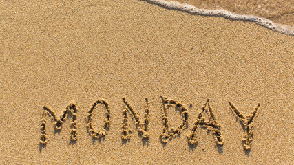 Monday - word drawn on the sand beach with the soft wave.