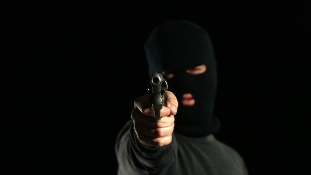 Criminal in ski mask shoots gun, slow motion