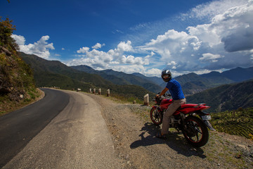Fototapeta na wymiar Motorbiker travelling in mountains