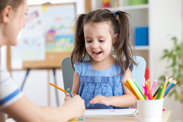 Woman helping her daughter with homework