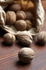 walnuts are closeup scattered in the package on the wooden brown table