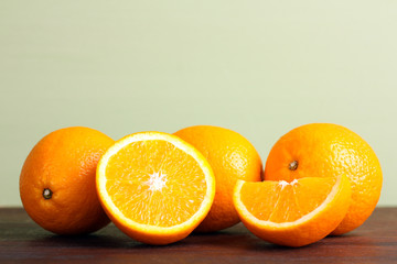 delicious sliced oranges on a brown wooden table on light background