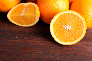 delicious sliced oranges lay in a heap on brown wooden table