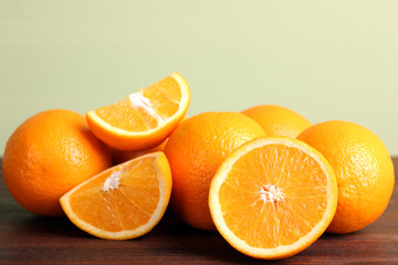 delicious sliced oranges on a brown wooden table on light background