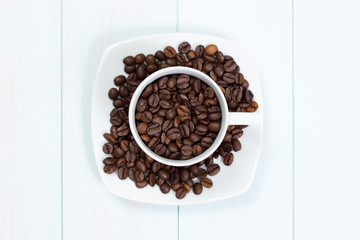 Coffee cup with coffee beans on table