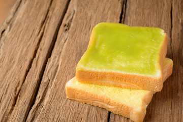 sliced thai custard bread on wood table