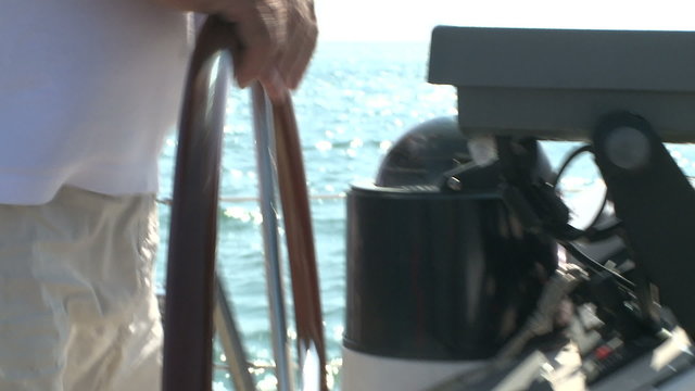 Sailing vessel captain holding the wheel