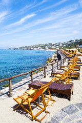 Fototapeta na wymiar holidays background chairs on the beach near sea