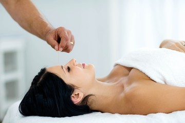 Obraz na płótnie Canvas Pregnant woman receiving a spa treatment from masseur