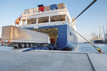 Fototapeta premium Ferry and Trucking Transportation - RO-RO Transport (Roll On/Roll Off)