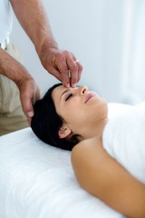 Fototapeta na wymiar Pregnant woman receiving a head massage from masseur