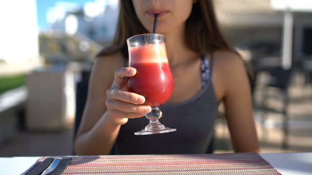 Healthy eating young woman drinking beet juice breakfast at restaurant table. Unrecognizable person holding glass of fresh vegetable smoothie for a vegetarian diet detox cleanse. Health trend.