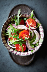 Fototapeta na wymiar Cherry tomato and arugula salad with sesame seeds