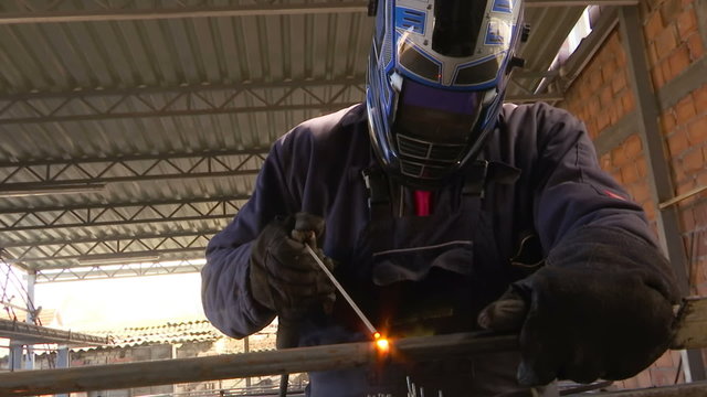 Welder carries out welding of metal