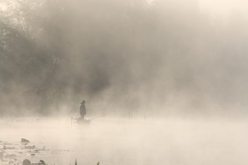 Fishing in foggy morning