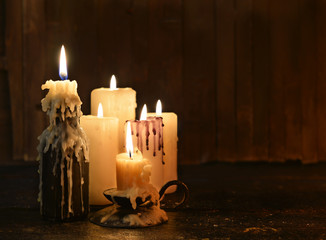 Group of candles burning in the darkness and copy space