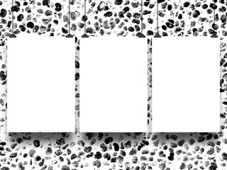 Close-up of three hanged blank frames with clips on black and white ink splotchy background