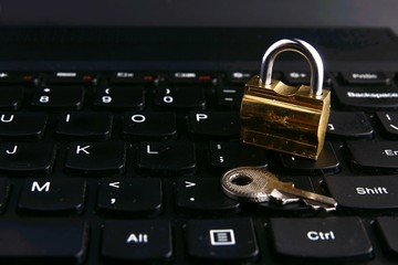 Padlock and key on a computer keyboard