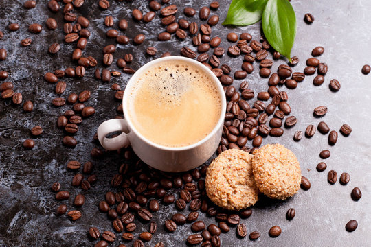 cup of fresh americano and cookies on coffee beans background © katrinkivi
