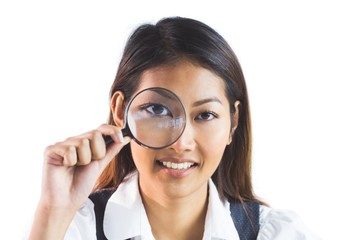 Businesswoman looking through magnifying glass