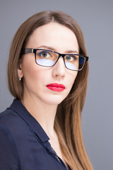 Fototapeta na wymiar Young confident business woman in glasses