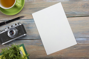 Tourism, travel concept. Office desk table with notepad, camera and supplies. Top view. Copy space for text.