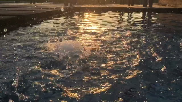 slow motion water drop on a pool, silhouette in the evening
