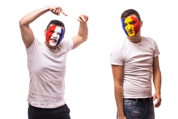 France vs Romania on white background. Football fans of Romania and France national teams demonstrate emotions: Romanian lose, France win. European football fans concept.