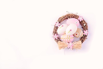 Easter eggs painted in pastel colors in the nest