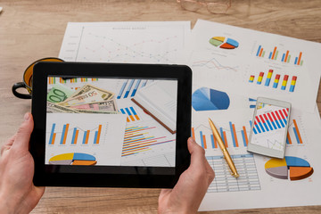 man hands hold tablet with business graph on desk