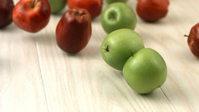 Red and green apples, slow motion