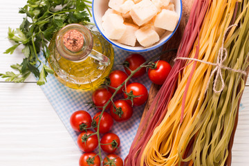  Vegetable color Pasta, oil,tomatoes,cheese on wooden table. italian food