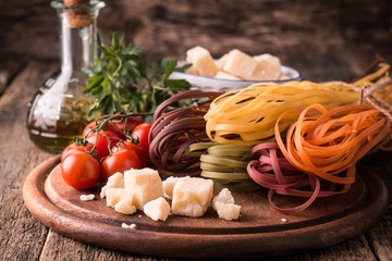  Vegetable color Pasta, oil,tomatoes,cheese on wooden table. italian food
