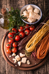  Vegetable color Pasta, oil,tomatoes,cheese on wooden table. italian food