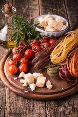  Vegetable color Pasta, oil,tomatoes,cheese on wooden table. italian food