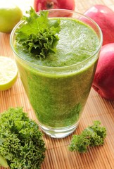 Glass of green smoothie with kale, apple and lime