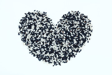 Heart shaped sesame seeds isolated on white
