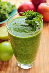 Fresh and healthy smoothie with kale leafs, red apple and lime