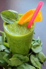 Smoothie with spinach and orange in a glass