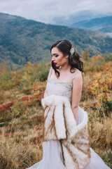 Fototapeta na wymiar Beautiful bride posing in high mountain scenery