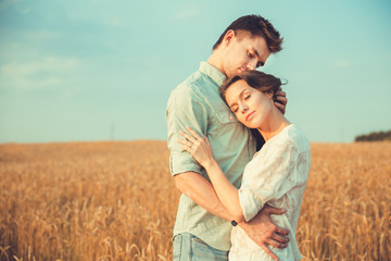 Young couple in love outdoor.Stunning sensual outdoor portrait of young stylish fashion couple posing in summer in field 