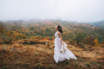 Beautiful bride posing in high mountain scenery