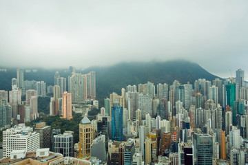 Fototapeta na wymiar Skyscrapers on green hills before rain in Hong Kong