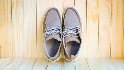 gray suede shoes on wooden background