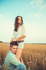 Young couple in love outdoor.Stunning sensual outdoor portrait of young stylish fashion couple posing in summer in field