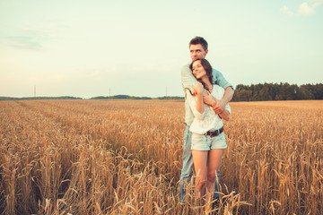 Young couple in love outdoor.Stunning sensual outdoor portrait of young stylish fashion couple posing in summer in field