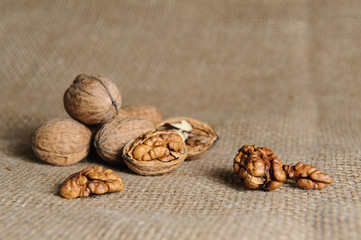 Walnut kernels and whole walnuts on burlap