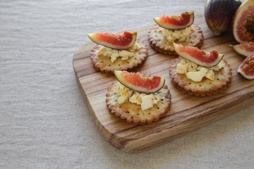 Cracker canapes with fresh fig and cream cheese, selective focus